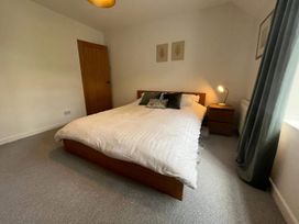 A bedroom with a bed and nightstand at Charming 3Bed Cottage Private Garden Parking Torquay