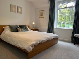 A bedroom with a bed and window at Charming 3Bed Cottage Private Garden Parking in Torquay