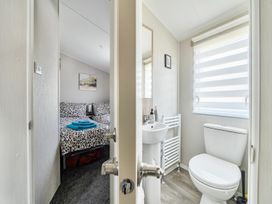 A bathroom with a sink and toilet at Cayton Bay Holiday Park Kestrel40 Cayton Bay