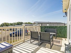 A balcony with seating and a view at Cayton Bay Holiday Park Kestrel40, Cayton Bay