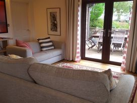 A living room with a sofa and door to the outside at 2bed sleeps4 pool freeparking Trenythonestate Near Par