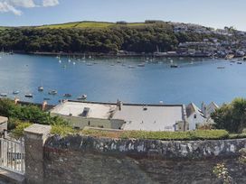 A view of boats on water with hills and buildings at 2bed sleeps4 pool freeparking Trenythonestate Near Par