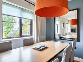 A dining room with table and chairs at 2bed sleeps4 pool freeparking Trenythonestate near Par