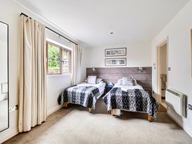 A bedroom with two beds and a window at 2bed sleeps4 pool freeparking Trenythonestate Near Par