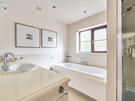 A bathroom with a tub and sink at 2bed sleeps4 pool freeparking Trenythonestate near Par