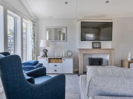 A living room with a TV and sofa at Atlantic Breeze Luxury Lodge sleep 6 Mullacott near Ilfracombe