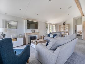 A living room with a sofa and television at Atlantic Breeze Luxury Lodge sleep 6 Mullacott near Ilfracombe