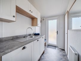 A kitchenette with sink and cabinets at Atlantic Breeze Luxury Lodge sleep 6 Mullacott near Ilfracombe