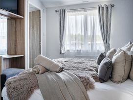A bedroom with a bed and pillows at Atlantic Breeze Luxury Lodge sleep 6 Mullacott near Ilfracombe