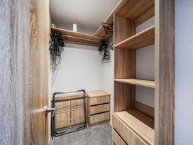 A closet with shelves and storage drawers at Atlantic Breeze Luxury Lodge sleep 6 Mullacott near Ilfracombe