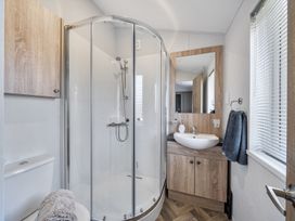 A bathroom with shower, sink, and toilet at Atlantic Breeze Luxury Lodge sleep 6 Mullacott near Ilfracombe