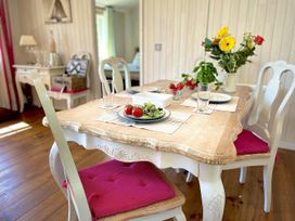 A dining room with a wooden table and chairs at Stunning Sleeps 6 Luxury Lodge Pets Mercia Marina near Willington, Derbyshire