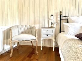 A bedroom with a bed and bedside table at Stunning Sleeps 6 Luxury Lodge Pets Mercia Marina near Willington, Derbyshire