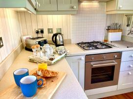 A kitchen with a toaster, kettle, and breakfast items at Stunning Sleeps 6 Luxury Lodge Pets Mercia Marina near Willington, Derbyshire
