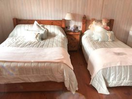 A bedroom with two beds and a nightstand at Stunning Sleeps 6 Luxury Lodge Pets Mercia Marina near Willington, Derbyshire