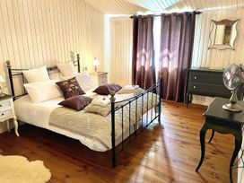 A bedroom with a bed and nightstand at Stunning Sleeps 6 Luxury Lodge Pets Mercia Marina near Willington, Derbyshire