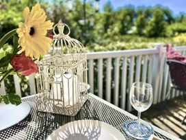 A table set with flowers, a candle holder, and glassware at Stunning Sleeps 6 Luxury Lodge Pets Mercia Marina near Willington, Derbyshire