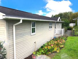An exterior view of a house with plants and a gravel path at Stunning Sleeps 6 Luxury Lodge Pets Mercia Marina near Willington, Derbyshire