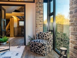 A snug area with an armchair and a staircase at the property in 