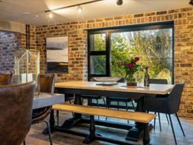 A dining room with a table and chairs at  