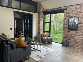 A living room with a sofa, coffee table, and green view at the property in 