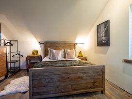 A bedroom with a wooden bed and nightstand at the property in the location