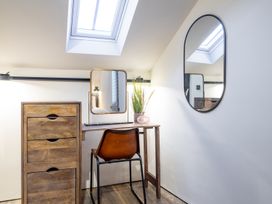 An office area with a desk, mirror, and plant at the property in 