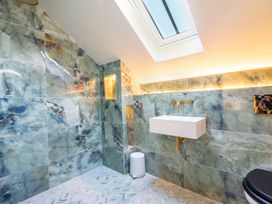A bathroom with a sink and shower area at the property