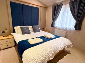 A bedroom with a bed and pillows at Meadows 33 Hot tub Southview Holiday Park in Skegness