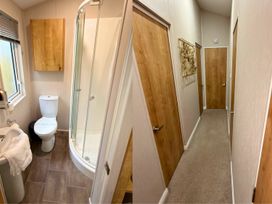 A bathroom with a toilet, shower, and sink at Meadows 33 Hot tub Southview Holiday Park in Skegness