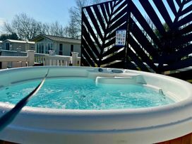 A hot tub on a deck surrounded by a fence at Meadows 33 Hot tub Southview Holiday Park Skegness