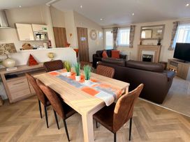 A dining area with a table and chairs at Sunset 19 Southview Holiday Park Skegness