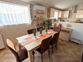 A dining room with a table and chairs at Sunset 19 Southview Holiday Park Skegness