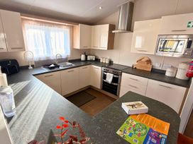 A kitchen with cabinets and countertop at Sunset 19 Southview Holiday Park Skegness