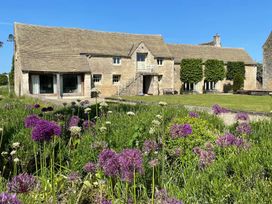 A house with stairs and a garden at Stunning 6 Bedroom Riverside Barn Cotswold Mill Ewan near Kemble