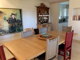 A dining room with a table and chairs at Stunning 6 Bedroom Riverside Barn Cotswold Mill Ewan near Kemble