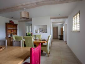 A dining room with table and chairs at Stunning 6 Bedroom Riverside Barn Cotswold Mill near Kemble