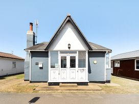 A house with a chimney and door at Seahorse Chalet Sleeps 6 Pets Log Burner Beach in Bridlington