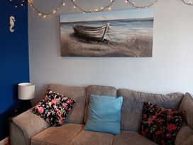 A living room with a sofa and wall art at Seahorse Chalet Sleeps 6 Pets Log Burner Beach in Bridlington