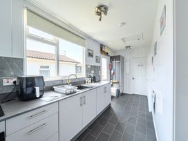 A kitchen with cabinets and appliances at Seahorse Chalet Sleeps 6 Pets Log Burner Beach in Bridlington