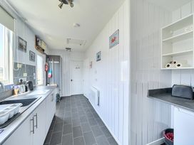 A kitchen with sink and refrigerator at Seahorse Chalet Sleeps 6 Pets Log Burner Beach in Bridlington
