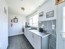 A kitchen with a sink and kettle at Seahorse Chalet Sleeps 6 Pets Log Burner Beach in Bridlington