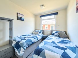 A bedroom with two beds and a bedside table at Seahorse Chalet Sleeps 6 Pets Log Burner Beach in Bridlington