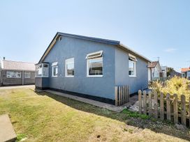 A house with windows and a fence at Seahorse Chalet Sleeps 6 Pets Log Burner Beach in Bridlington