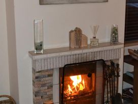 A fireplace with decorative items on the mantel at Sea Side Stay 6 Pet Friendly Parking Garden Rhosneigr