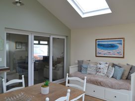 A living room with a sofa and table at Sea Side Stay 6 Pet Friendly Parking Garden Rhosneigr