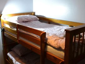 A bunk bed with mattresses and pillows at Sea Side Stay 6 Pet Friendly Parking Garden Rhosneigr
