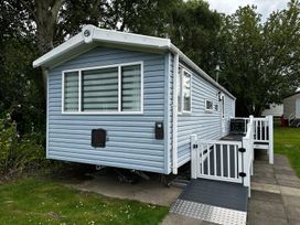 A mobile home with steps and a handrail in an outdoor area
