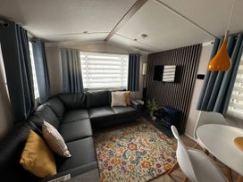A living room with a sofa and dining table at The Old Barn in Manchester