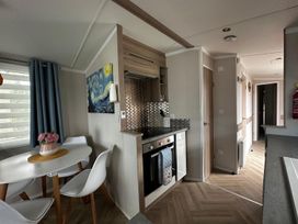 A kitchen with dining table and chairs at The Old Barn in Manchester